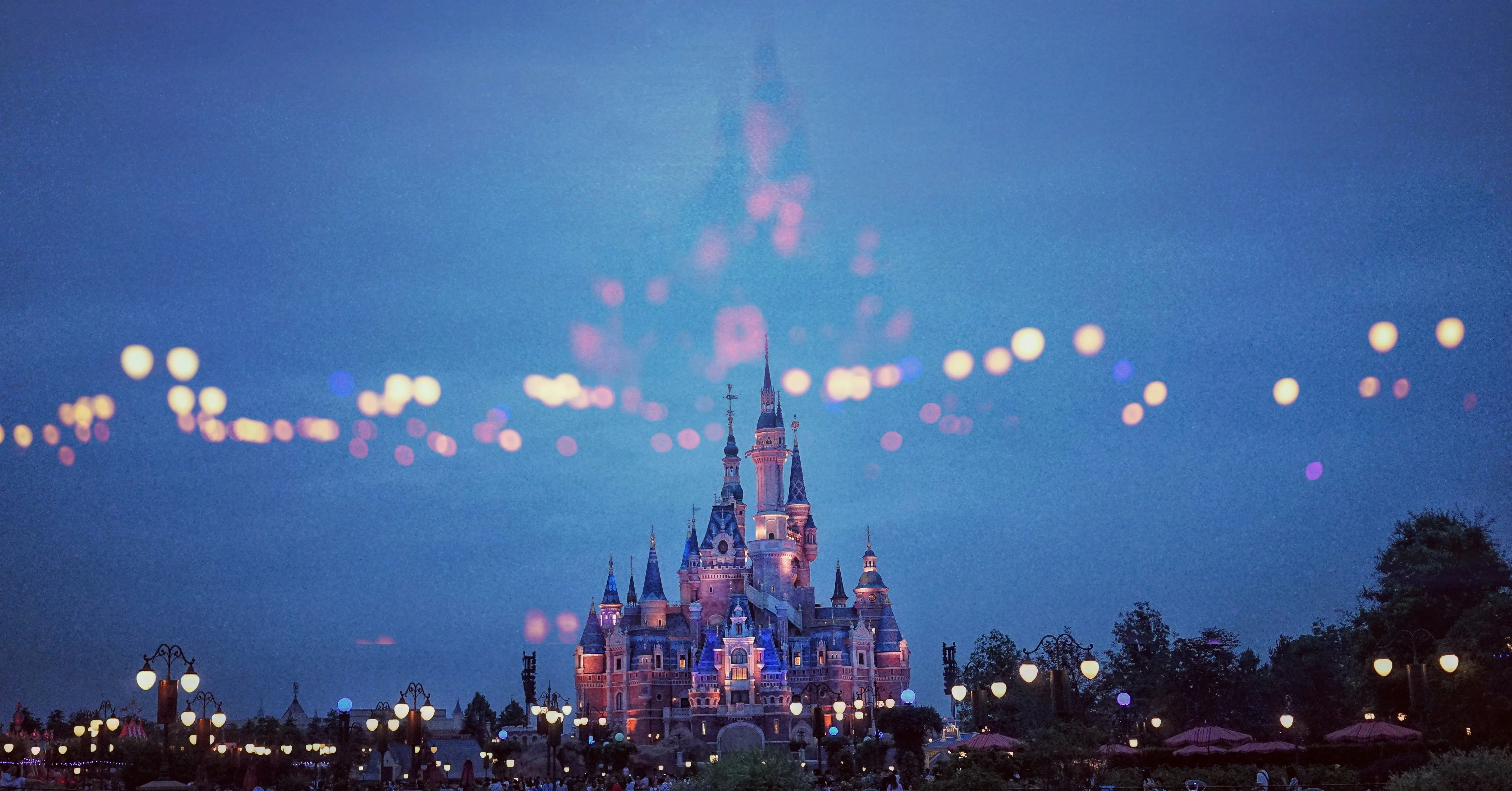 Disney castle at dusk with magical lights - perfect background for a Disney countdown widget